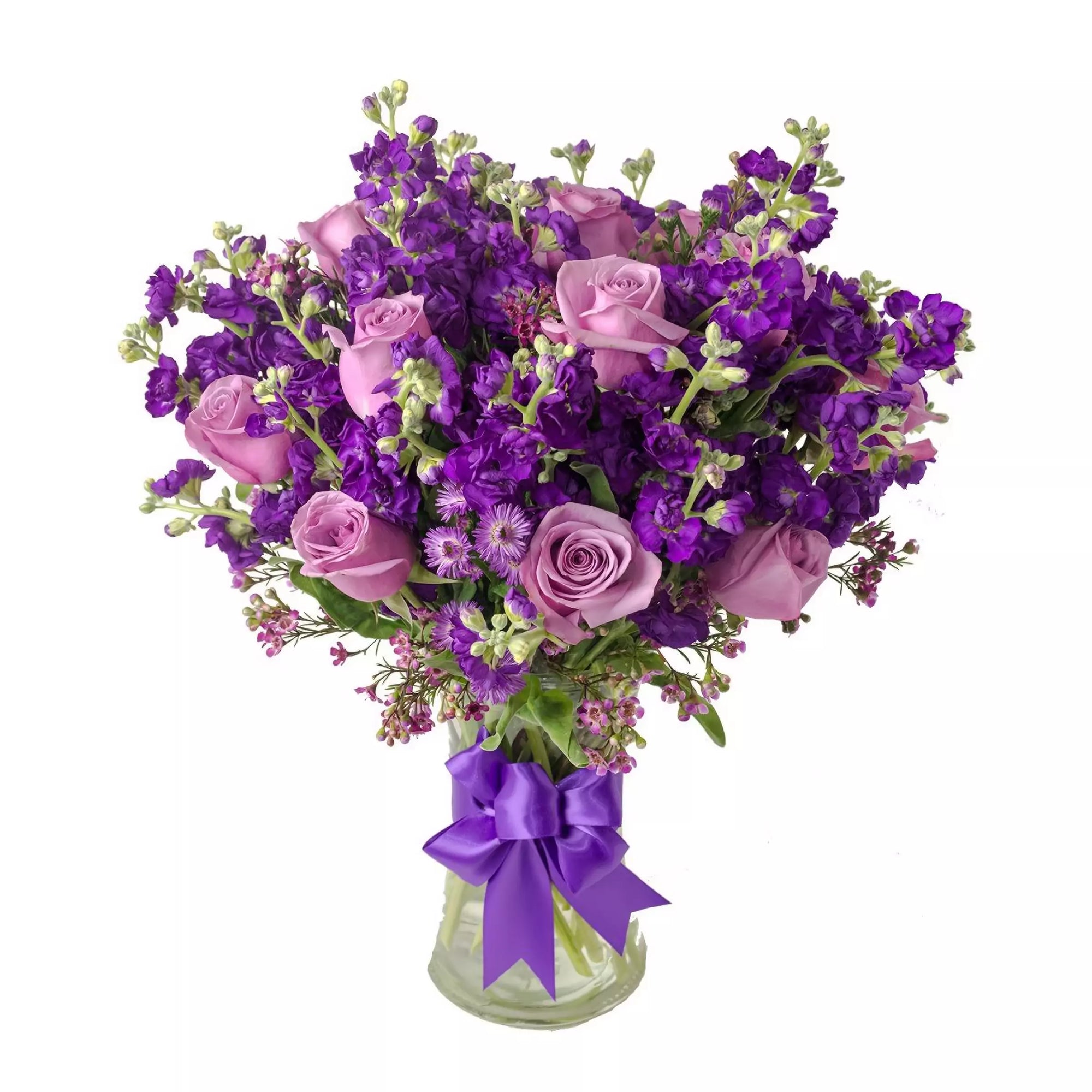 A gorgeous arrangement of purple and lavender roses, stock and waxflower, accented with fresh greens.